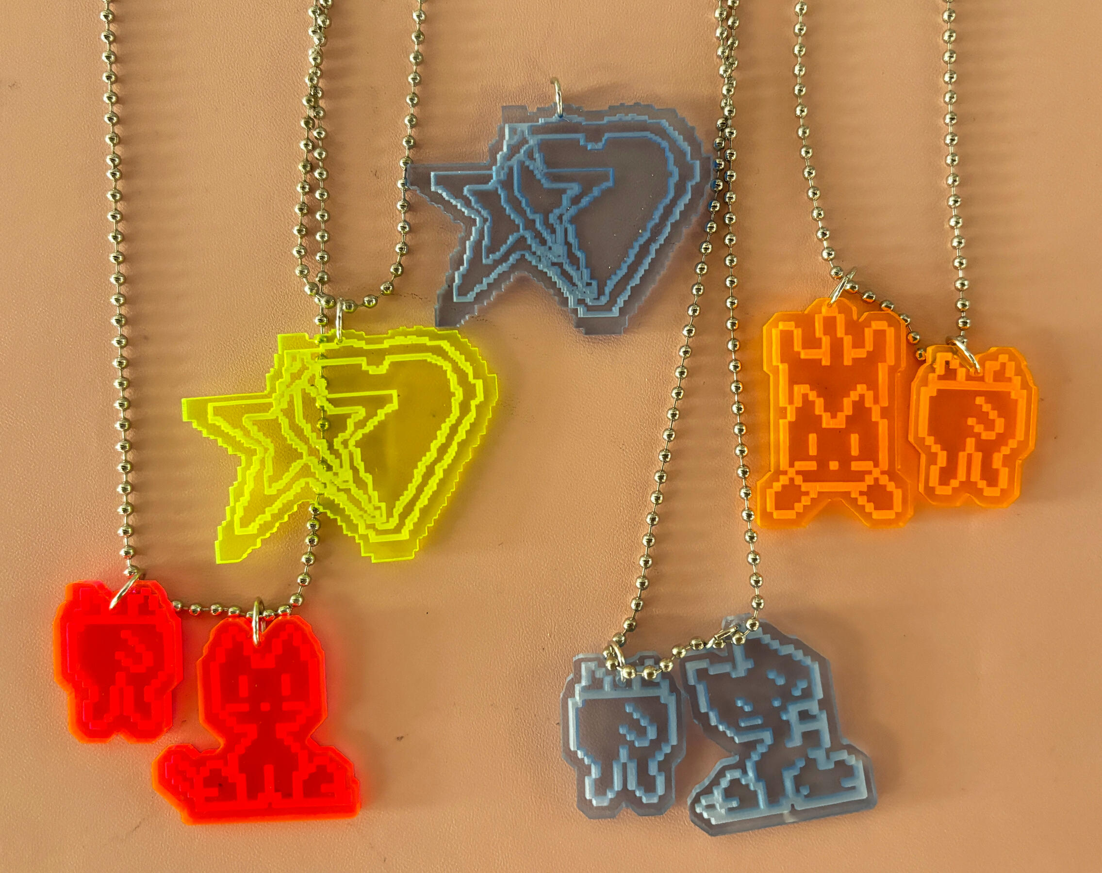 necklaces (heartstar, pixel cats) 2024 laser cut acrylic, jump rings, ball chains